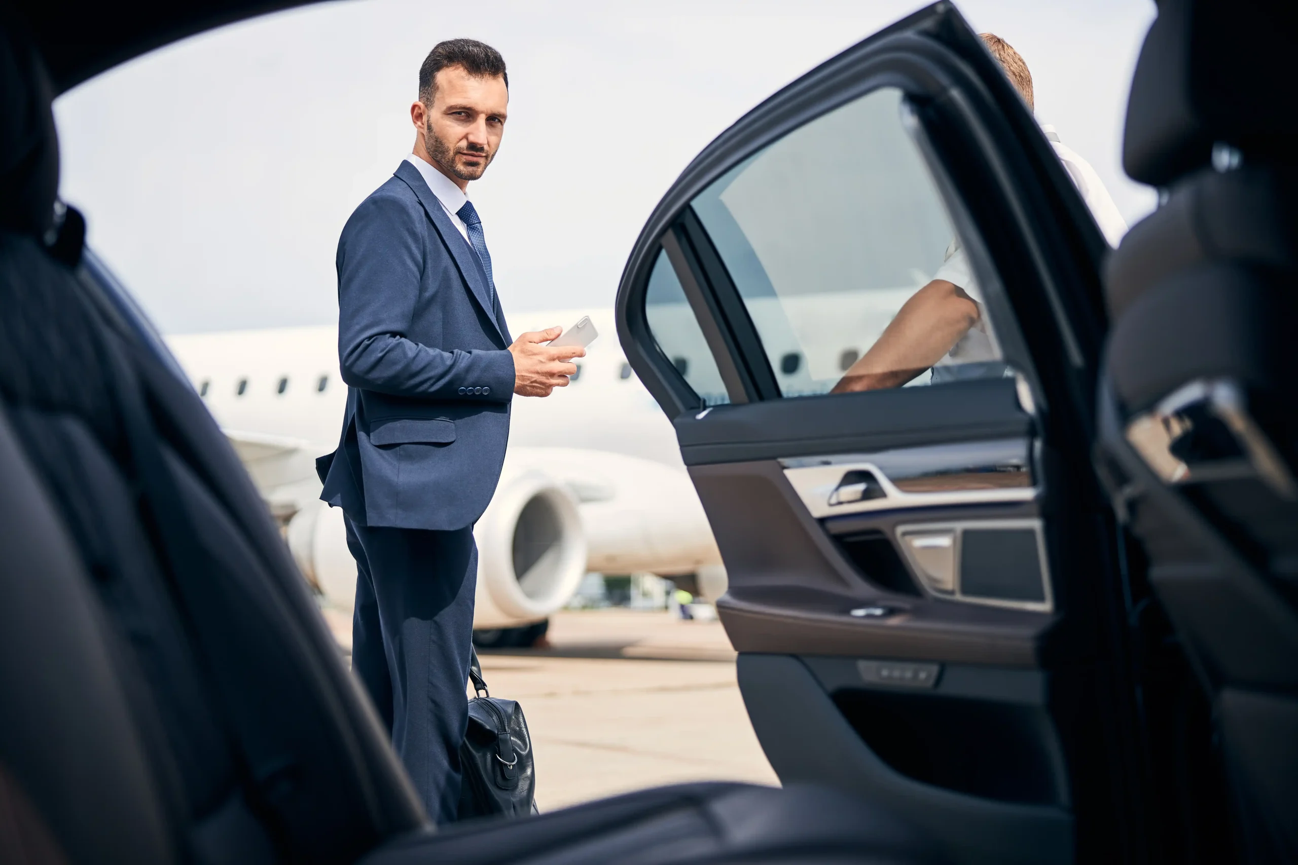 well-dressed-businessman-arriving-by-plane-and-car-2026-01-05-22-56-31-utc